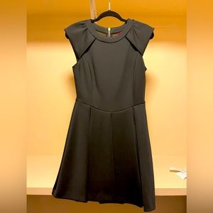 Flared Ted baker black dress with gold zip and mesh detail.